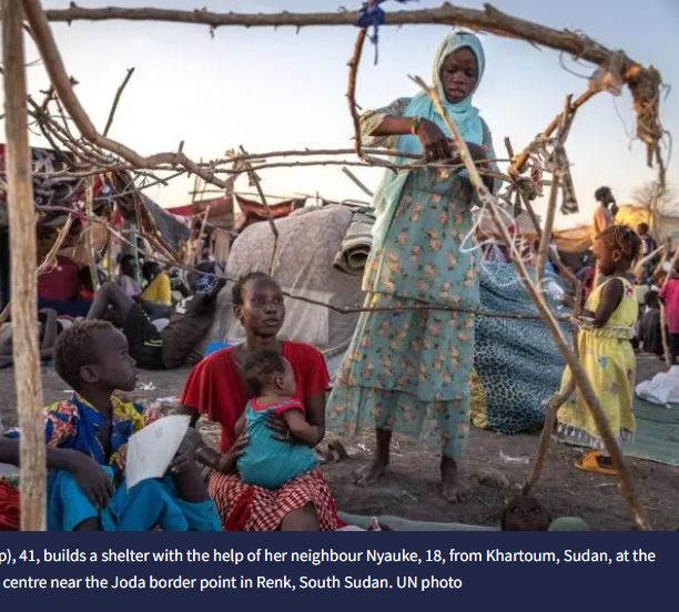 Eliza (red shirt) builds a shelter with her neighbour Nyauke. She sits holding a child with another boy next to her.