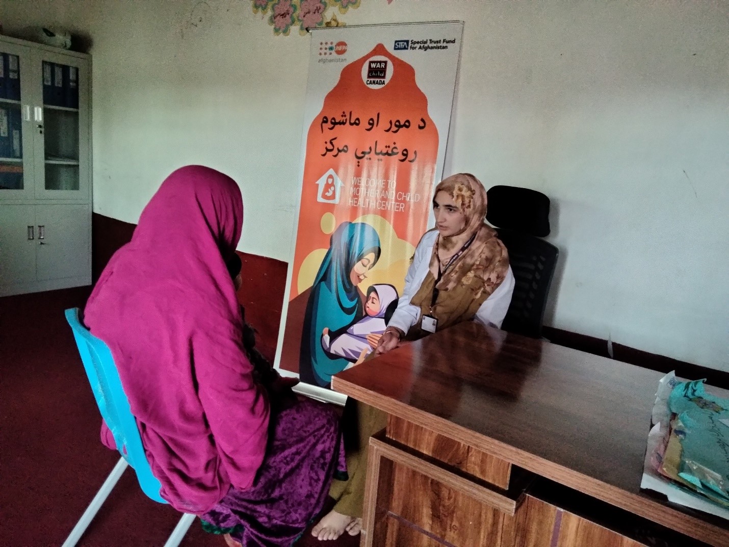 A woman in Afghanistan receiving support to access safe medical care.