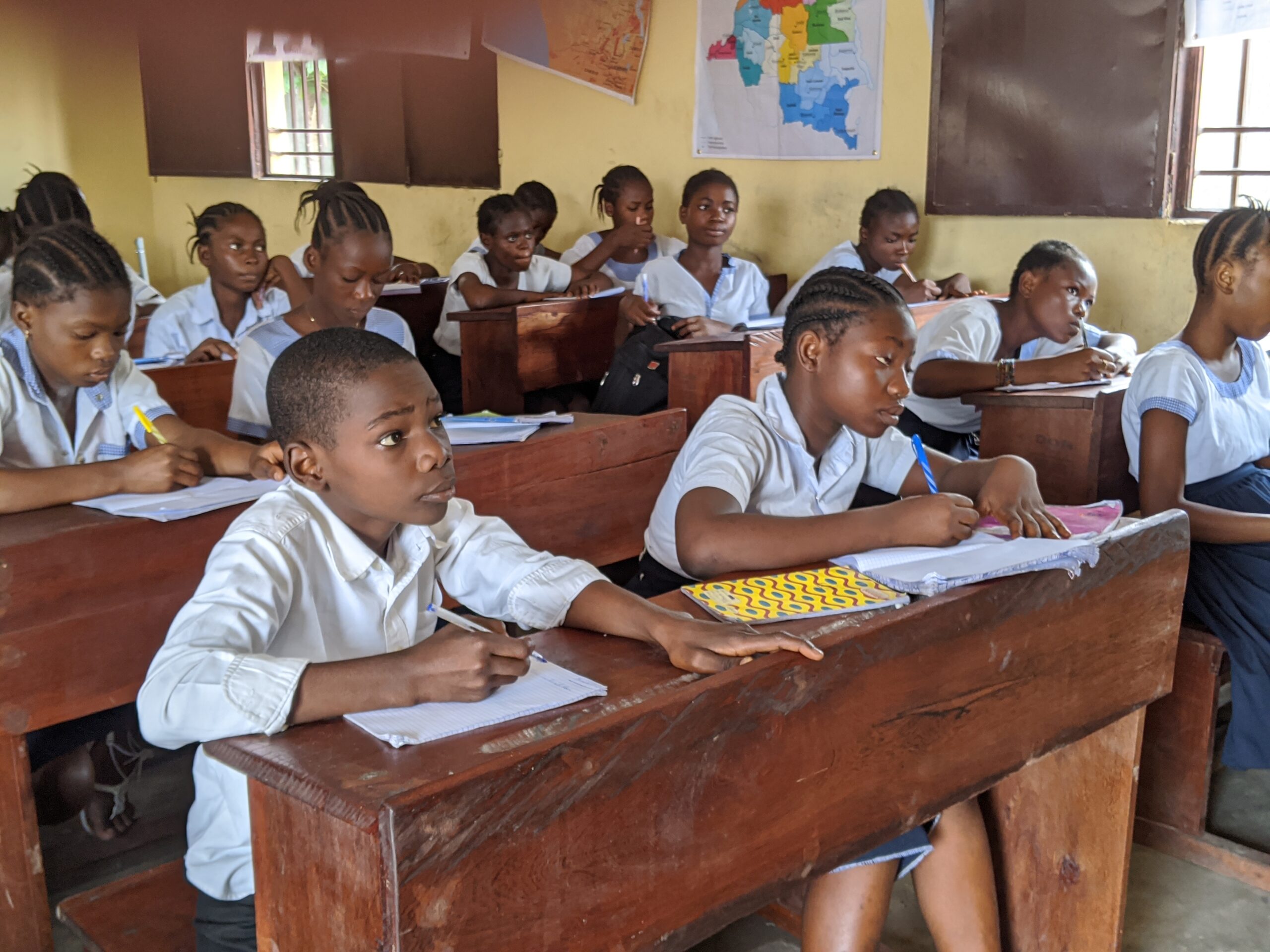 Students in DRC learning via radio instruction.