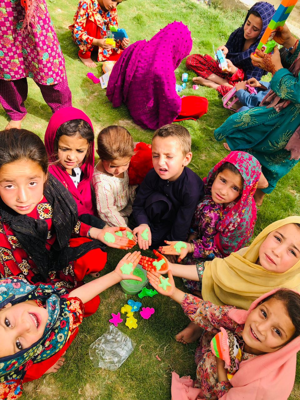 Kids playing and looking up at the camera in Afghanistan